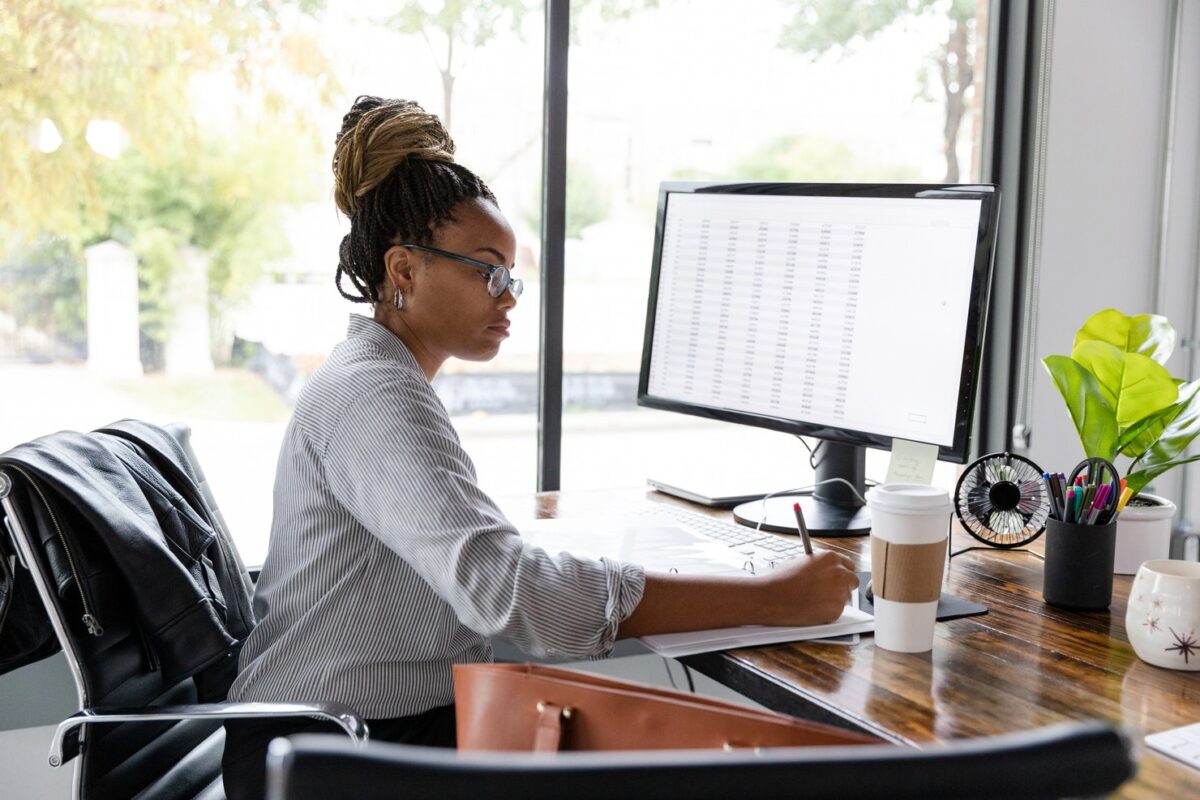 Healthcare worker sitting at a computer desk doing analytics