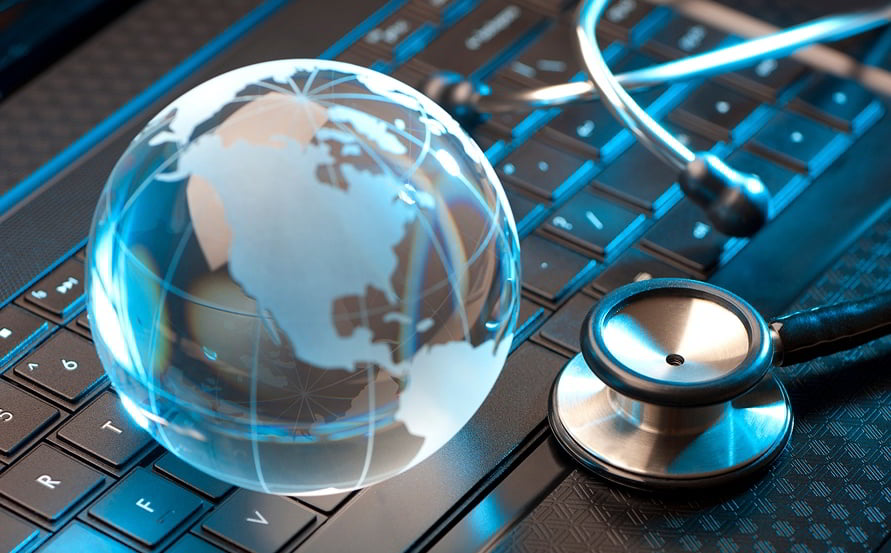 Glass globe and stethoscope on keyboard representing global healthcare data impact