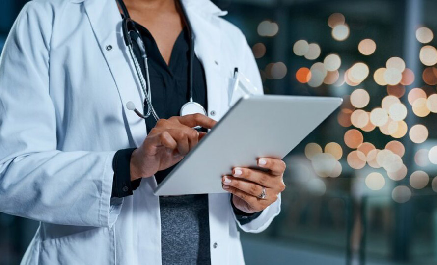 Close-up of medical professional using a tablet.