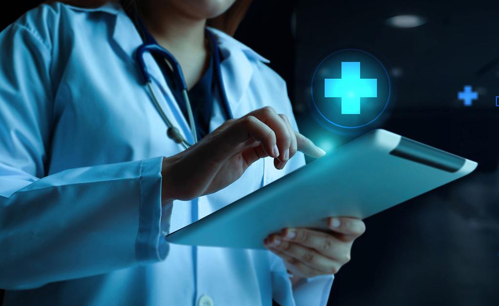 Doctor using tablet with medical cross symbol and digital interface overlay