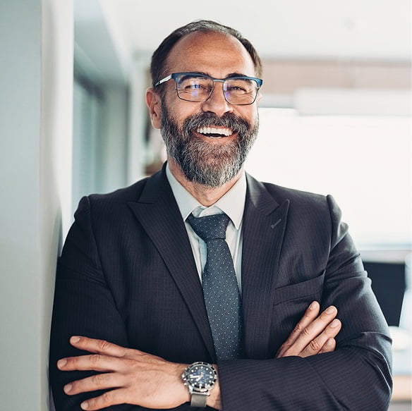 Business professional in a suit smiling, representing HelathTech leadership