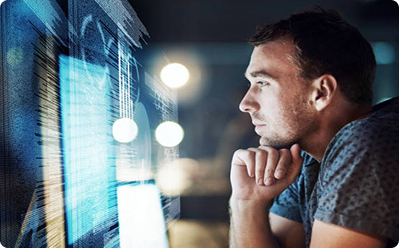 Male healthcare professional analyzing clinical data on multiple monitors