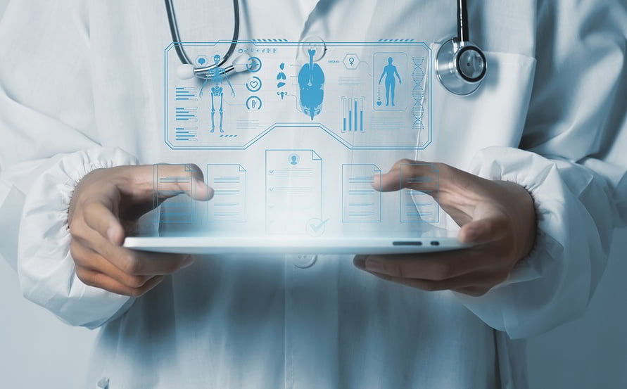 Medical professional reviewing patient story on a laptop