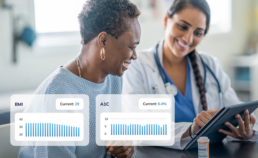 Female healthcare provider reviewing health information on a tablet with a patient