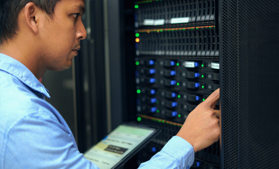 IT professional working with server equipment in a data center.