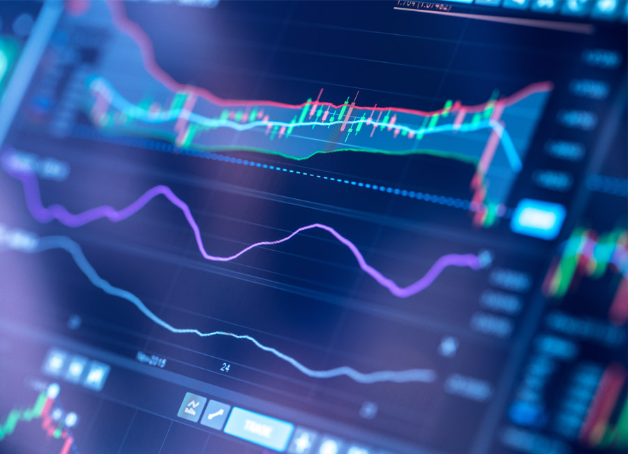 Close-up of digital data visualization with charts and trend lines on a screen.