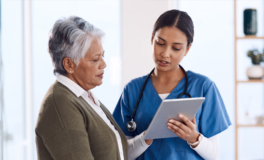 Doctor showing a patient information on a digital tablet during a consultation.